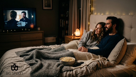 couple watching movie in bed